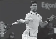  ?? KARIM JAAFARKARI­M JAAFAR/AFP/GETTY IMAGES ?? Novak Djokovic of Serbia returns the ball to Rafael Nadal of Spain during the final of the Qatar Open tennis tournament Jan. 9 in Doha.