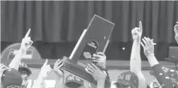  ?? ANDYLYONS/GETTY ?? UCLA’s Tyger Campbell celebrates with the East Regional Champion trophy after defeating Michigan in the Elite Eight on Tuesday in Indianapol­is, Indiana.