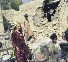  ?? ARSHAD BUTT THE ASSOCIATED PRESS ?? A family is seen inside its house following an earthquake in Harnai, Pakistan. The powerful earthquake collapsed at least one coal mine and dozens of mud houses in southwest Pakistan early Thursday.