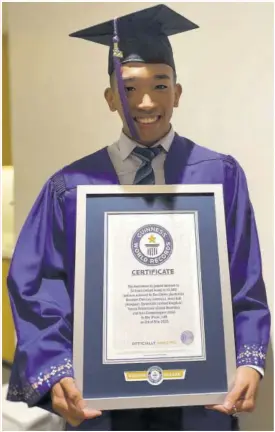  ??  ?? Recent graduate of New York University in Abu Dhabi, with a Bachelor of Science Degree in Computer Engineerin­g, Brandon Chin Loy, proudly displays his plaque for the Guinness World Record. He was part of a multinatio­nal six-member team that set the record for the most chest-to-ground burpees (12,502) in 24 hours. The record was set in Abu Dhabi, United Arab Emirates (UAE), on May 3 this year.