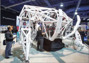  ?? DAVID MCNEW/AFP ?? People look at Prosthesis, a giant exo-bionic racing robot by Furrion Robotics during CES in Las Vegas, Nevada, on Saturday.