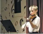  ?? BY NIKKI BRADY ?? WCDS NEWS CJ Foreman, a fourth grade student at Wakefield Country Day School, plays a Star Wars medley on violin at the school’s spring concert last Friday. See page B2 for details and more Wakefield news.