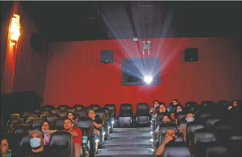  ?? (AP/Natacha Pisarenko) ?? People watch a movie at a cinema after almost a year of theaters being closed due to the pandemic in Buenos Aires, Argentina.