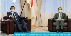  ?? – AFP ?? TOKYO: Japanese Finance Minister Taro Aso (left) meets with Bank of Japan Governor Haruhiko Kuroda in Tokyo on Friday.