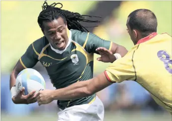  ?? PICTURE: REUTERS ?? Cecil Afrika fends off a tackle from Spain’s Igor Genua Sistiaga at the Deodoro Stadium in Rio last night.