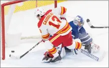  ?? CP PHOTO FRANK GUNN ?? Calgary Flames’ Johnny Gaudreau scores the game winning goal on Toronto Maple Leafs goaltender David Rittich in overtime in Toronto on Tuesday.