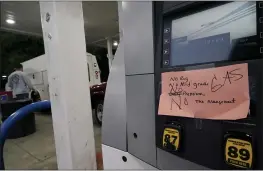  ?? CHRIS CARLSON — THE ASSOCIATED PRESS ?? A hand written sign is posted on a gas pump, showing that the service station is out of all grades of fuel Wednesday in Charlotte, N.C. Several gas stations in the Southeast reported running out of fuel, primarily because of what analysts say is unwarrante­d panicbuyin­g among drivers, as the shutdown of a major pipeline by hackers entered its fifth day.