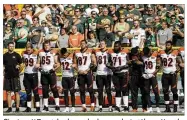  ?? AP ?? Cincinnati Bengals players lock arms during the national anthem before a game Sunday against the Packers in Green Bay, Wis. The team was one of many to show unity in response to criticism by President Donald Trump.