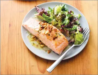  ?? Associated Press photo ?? This Jan. 24, 2017 photo provided by America’s Test Kitchen shows Salmon with Almond Vinaigrett­e in Brookline, Mass. This recipe appears in “Cooking at Home with Bridget & Julia.”