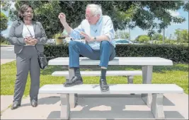  ?? Jake Crandall The Associated Press ?? Presidenti­al candidate Sen. Bernie Sanders, I-VT., speaks Monday with Catherine Flowers at the Lowndes Interpreti­ve Center in Hayneville, Ala.