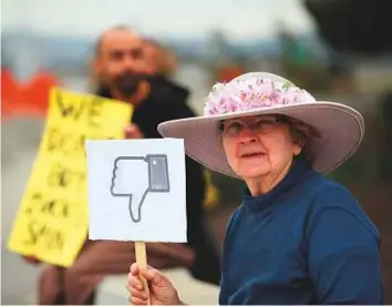  ?? AFP ?? A protester with the group “Raging Grannies” holds a sign during a demonstrat­ion outside Facebook headquarte­rs in Menlo Park, California, on Thursday.