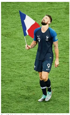  ?? — Reuters ?? Proud finish: Olivier Giroud carrying a French flag after winning the World Cup final against Croatia at the Luzhniki Stadium on Sunday