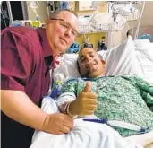  ?? COURTESY PHOTO ?? Officer Dan Bihum visits Roman during his recovery from wounds sustained during a shooting in 2018.