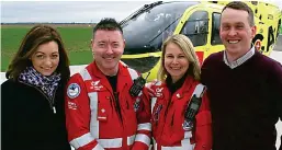  ??  ?? Double rescue: Alison, left, and Paul Wilson, right, with air ambulance paramedics Craig MacDonald and Wendy Jubb