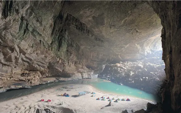  ?? PHOTOS: TIMM CHAPMAN ?? An expedition team set up a camp inside the mouth of Hang Én, the third-largest cave in the world and a direct route to Hang Son Đoòng, the world’s largest cave.