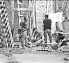  ??  ?? Volunteers having a break before continuing with clean-up work.