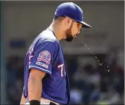  ?? LOUIS DELUCA / AP ?? Rangers third baseman Isiah Kiner-Falefa spits during a game last season. Baseball probably owes its fondness for the art of spitting to its roots as a working-man’s game played on sandlots and dusty diamonds.