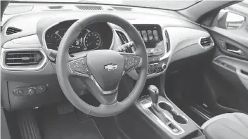  ??  ?? Like the Chevrolet Malibu, the dash of the Equinox 2.0T has clear and logically placed controls and major gauges.