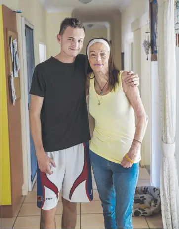  ?? Picture: MARK CRANITCH ?? SUPPORT: Carol Mayer, at her Cairns home with son Zac, 19, was 33 when she sustained burn injuries to over 80 per cent of her body after a fire in February 2000.