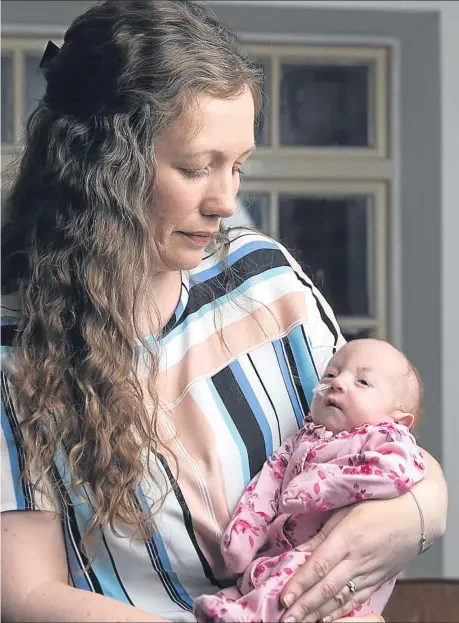  ??  ?? Devoted mum Gina cradles precious daughter Willow at home in Fyvie, Aberdeensh­ire