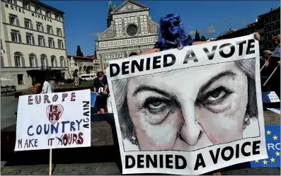  ?? Photo: VCG ?? Anti-Brexit protesters hold signs that read, “Europe is my country – make it (y)ours again” and “Denied a vote” on Friday in Florence, Italy, where British Prime Minister Theresa May delivered a speech.