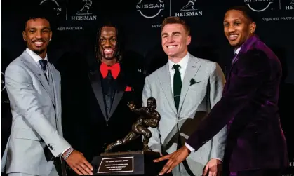  ?? ?? Heisman Trophy finalists, from left, LSU quarterbac­k Jayden Daniels, Ohio State wide receiver Marvin Harrison Jr, Oregon quarterbac­k Bo Nix and Washington quarterbac­k Michael Penix Jr pose with the trophy after attending a news conference ahead of the award ceremony on Saturday. Photograph: Eduardo Muñoz/AP