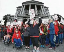  ?? David Zalubowski / Associated Press ?? Stephanie Rolf, center, a teacher in Douglas County, Colo., leads a cheer during a teachers rally in Denver in April.