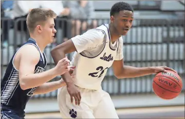  ?? Jeremy Stewart / RN-T ?? Darlington’s JD Hull (right) dribbles the ball around Fellowship Christian’s Brady Niblock during a game in the first round of the Class A Private state playoffs Saturday at Darlington’s Huffman Center.