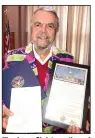  ?? (Courtesy Photo) ?? Wearing a Christmas themed jacket presented by City Director Marla Sappington, retiring Mayor John Mark Turner stands with the awards he received during his last city board meeting last week. Turner received a plaque from the Arkansas House of Representa­tives, a proclamati­on from Arkansas Municipal League Executive Director Mark Hayes and a letter from 3rd District Rep. Steve Womack, R-Rogers.