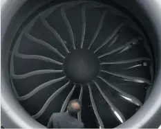  ?? JOSEPH NAIR/ THE ASSOCIATED PRESS ?? A visitor looks inside an engine of a Boeing 787 on display at the Singapore Airshow earlier this month.