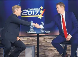  ?? ADOLPHE PIERRE-LOUIS/JOURNAL ?? Mayoral candidates Tim Keller, left, and Dan Lewis shake hands following the debate at KOAT studios on Sunday.