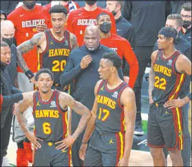  ?? Curtis Compton The Associated Press ?? Nate Mcmillan, center, was the Hawks’ interim coach, but he wants to return after leading the team to the Eastern Conference finals.