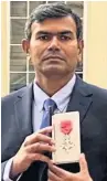  ??  ?? ●●Dr Chandra shows his MBE outside Buckingham Palace