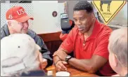  ?? Thomas hartwell ?? Herschel Walker, a Republican hoping to unseat U.S. Sen. Raphael Warnock, D-Ga., in the 2022 elections, talks with Cobb business and community leaders, as well as longtime residents, on a stop at The Red Eyed Mule in Marietta on Thursday morning, Oct. 14, as part of his statewide listening tour. Jerry Barfield, left, a member of a breakfast club at the restaurant, listens in.