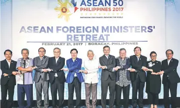  ??  ?? Associatio­n of South East Asian Nations (Asean) Foreign Ministers link arms during the Asean Foreign Ministers’ Retreat in Boracay, central Philippine­s. Yasay at sixth from left— Reuters photo