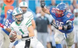  ?? [PHOTO BY BRYAN TERRY, THE OKLAHOMAN] ?? Max Wynn of Oklahoma Christian School puts pressure on Daniel Jackson of Jones during Friday’s high school football game in Edmond.