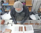  ?? TREVOR HUGHES/USA TODAY ?? A worker at Kiva Confection­s in Oakland, Calif., packages marijuana-infused chocolate bars.