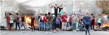  ??  ?? Iraqi protestors demonstrat­e against the government and the lack of basic services in the southern city of Basra. — AFP photo