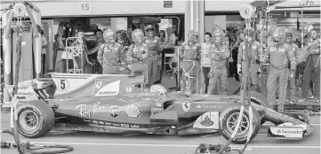  ?? — AFP photo ?? Ferrari’s Sebastian Vettel waits in the pits after being given a 10-second stop-go penalty during the Formula One Azerbaijan Grand Prix at the Baku City Circuit in Baku.