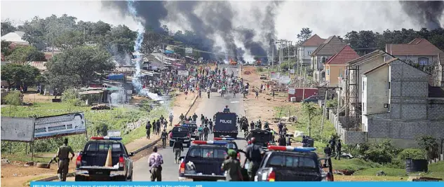  ?? —AFP ?? ABUJA: Nigerian police fire teargas at people during clashes between youths in Apo yesterday.