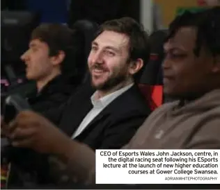  ?? ADRIANWHIT­EPHOTOGRAP­HY ?? CEO of Esports Wales John Jackson, centre, in the digital racing seat following his Esports lecture at the launch of new higher education courses at Gower College Swansea.
