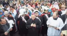  ?? Ned Gerard / Hearst Connecticu­t Media ?? Bishop Frank Caggiano leads a prayer at the start of the annual Living Stations of the Cross procession through Bridgeport’s East Side on Good Friday, April 19, 2019.