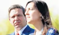  ?? WILFREDO LEE/AP ?? DeSantis listens as Lt. Gov.-elect Jeanette Nuñez speaks to the news media after a school roundtable in Fort Lauderdale in November.