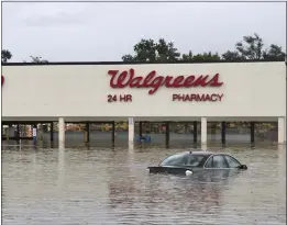  ?? MICHAEL B. THOMAS — THE NEW YORK TIMES ?? A flooded Walgreens store in a shopping area near Coldwater Creek in Florissant, Mo., is seen Tuesday after flash flooding. As much as a foot of rain fell in the St. Louis area.