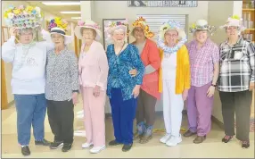  ?? Westside Eagle Observer/SUSAN HOLLAND ?? Entrants in the Easter bonnet contest at the Billy V. Hall Senior Activity Center line up Thursday and display their decorated hats. Pictured are Sue Rice (left), Fran Croxdale, Juanita Whiteside, Mary Griffin, LaVonda Augustine, Mavis Killeen, Linda Damron and Sue Peters. LaVonda Augustine, Mavis Killeen and Sue Peters were judged winners.