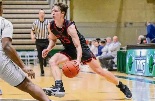  ?? Photos by Jim Franco/Times Union ?? Glens Falls junior Kellen Driscoll drives to the basket against Cohoes on Saturday. He had 18 points and 12 rebounds.