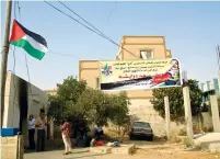  ?? (Tovah Lazaroff) ?? A POSTER outside the house in the village of Duma that was torched last week shows a picture of 18-month-old Ali Dawabsha, who was killed in the fire.