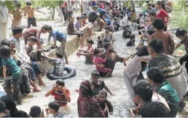  ?? K.M. Chaudhry / Associated Press ?? Families cool themselves off in a stream in Lahore, Pakistan. Deadly heat is getting worse as global warming continues, a new study shows.