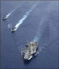  ?? ASSOCIATED PRESS ?? In this photo provided by US Navy, the USS Ronald Reagan (CVN 76) Carrier Strike Group steams in formation, in the South China Sea, July 6.