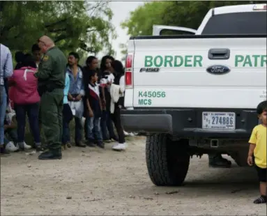  ?? AP PHOTO/ERIC GAY ?? In this Thursday, March 14, 2019, photo, William Josue Gonzales Garcia, 2, who was traveling with his parents, waits with other families who crossed the nearby U.S.-Mexico border near McAllen, Texas. They are waiting for Border Patrol agents to check names and documents. Immigratio­n authoritie­s say they expect the ongoing surge of Central American families crossing the border to multiply in the coming months.